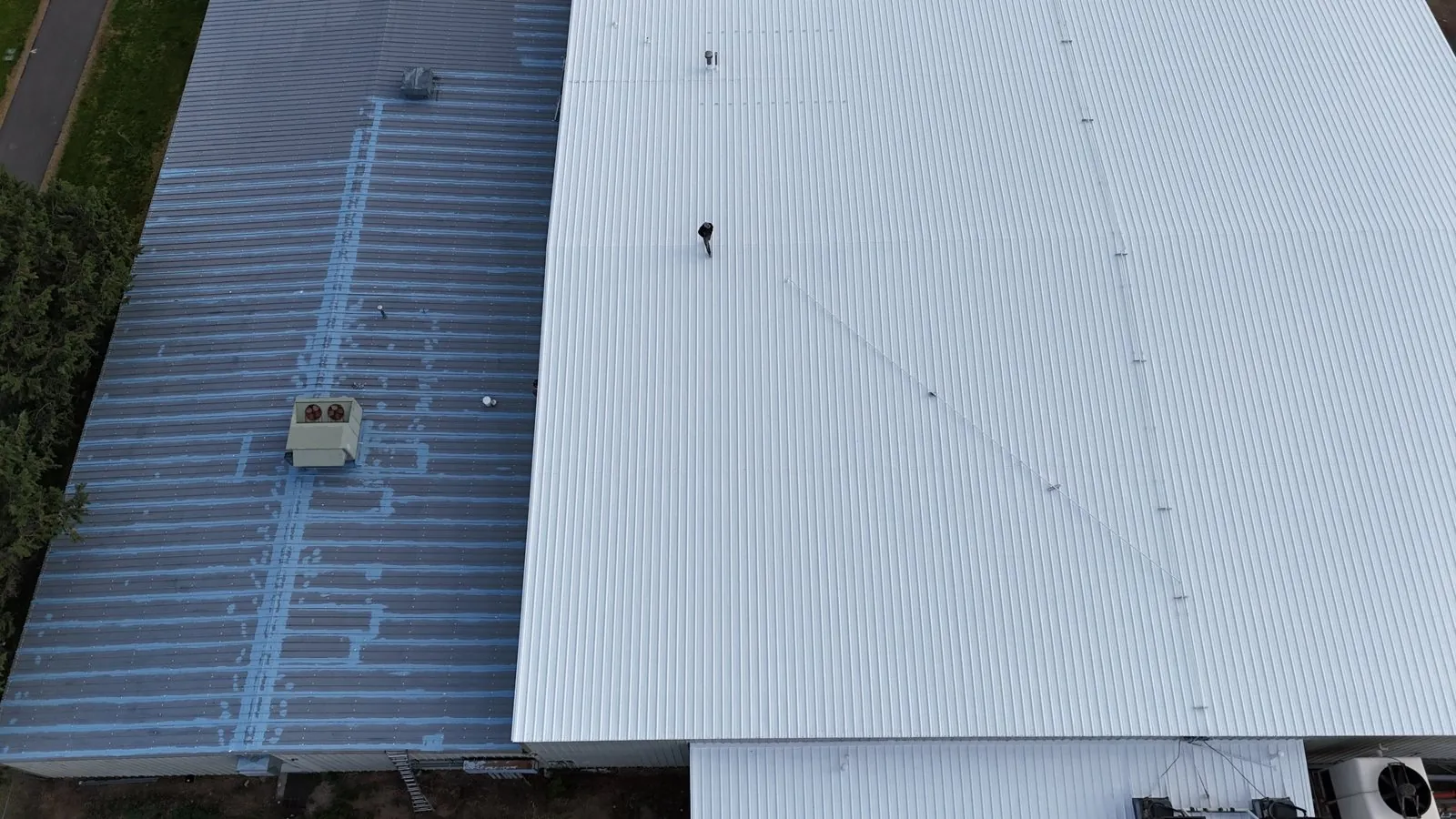 Metal roof mid-restoration seen from a drone