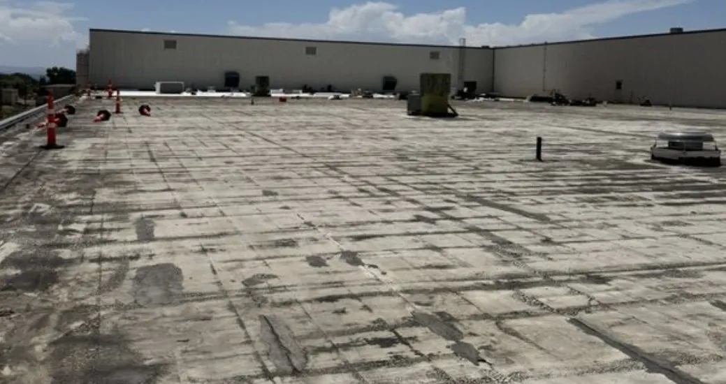 Spears Manufacturing roof before: worn, cracked roof surface